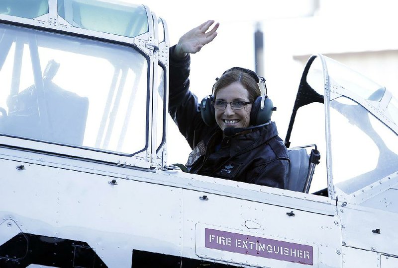 U.S. Rep. Martha McSally, R-Ariz., waves from a World War II-era T-6 airplane Friday at a stop in Tucson as she starts her campaign to replace Sen. Jeff Flake.  