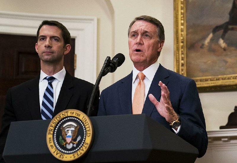 Sens. Tom Cotton (left) of Arkansas and David Perdue of Georgia, shown in August at the White House, said Friday that they did not recall President Donald Trump using vulgar language in a meeting on immigration policy.  