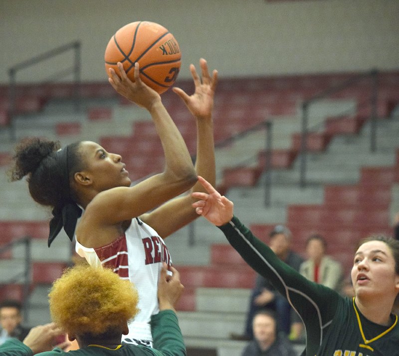 Submitted photo SCORING THREAT: Henderson State sophomore guard Pink Jones (2) attempts a shot in front of two Arkansas Tech defenders Thursday night at the Duke Wells Center. Jones had a career-high 26 points in a 75-52 win by the Reddies.