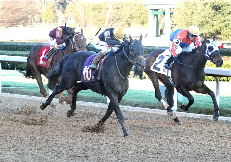 The Sentinel-Record/Richard Rasmussen FIRST TO FIFTH: Jockey C.J. McMahon guides Sonneteer (10) past Futile (2) and jockey Rodney Prescott near the wire en route to winning the $125,000 Fifth Season Stakes on opening day Friday at Oaklawn Park.