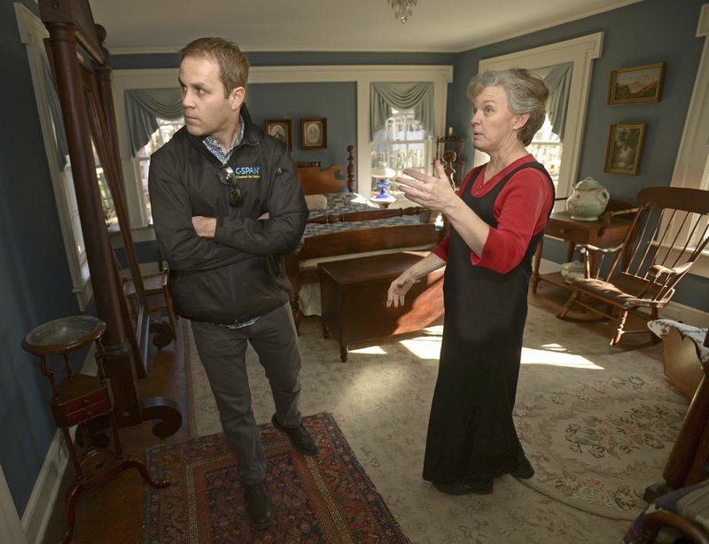 Scott Hummelsheim (left), a producer and video journalist with C-SPAN, speaks Wednesday with Judy Costello, director of historical programs for the Washington County Historical Society, while preparing to film a segment about Fayetteville at Headquarters House.