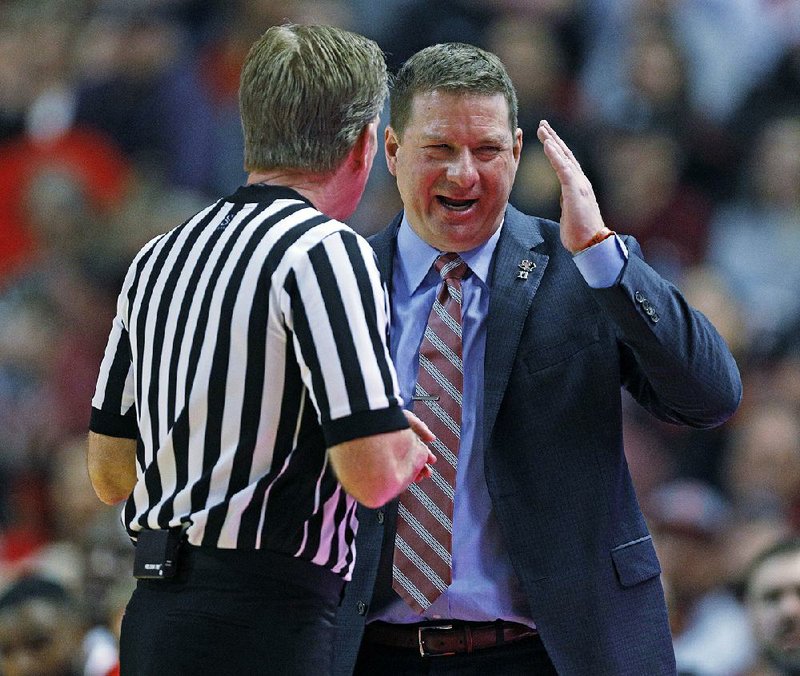 Texas Tech Coach Chris Beard makes his point with a referee during the Red Raiders’ 72-71 victory over No. 2 West Virginia on Saturday in Lubbock, Texas. 