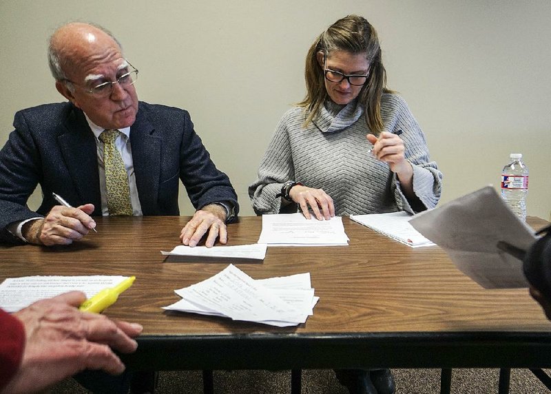 Little Rock District Judge Vic Fleming and senior probation officer Jennifer Cummings go over paperwork Saturday during “leniency court” at the Rights After Wrongs event in Little Rock. 