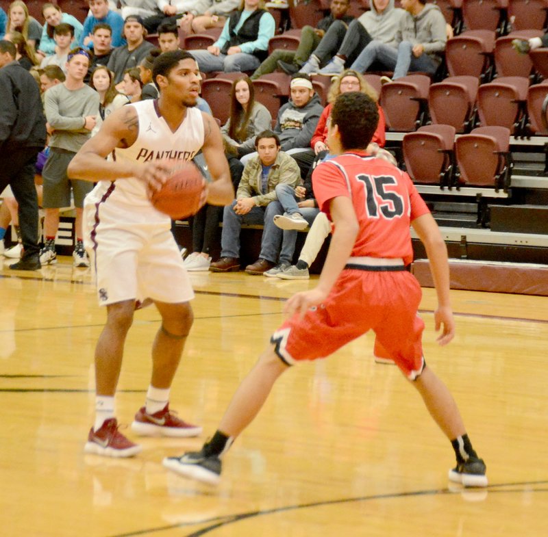 Graham Thomas/Siloam Sunday Siloam Springs senior Marquan Sorrells looks for a pass while Clarksville's Cameron Patterson defends during Tuesday's game at Panther Activity Center. Siloam Springs defeated Clarksville 61-50.