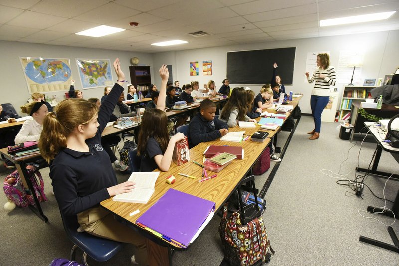 NWA Democrat-Gazette/FLIP PUTTHOFF Kelly Bankston teaches a literature class Wednesday at Northwest Arkansas Classical Academy in Bentonville. The school recently received a 10-year extension on its charter.