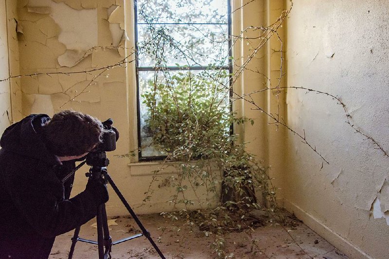 Michael Schwarz gets a shot of a tree that is making its way indoors through a broken window. Schwarz started Abandoned Arkansas in 2012.