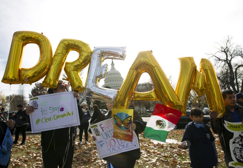 FILE - In this Dec. 6, 2017, file photo, demonstrators hold up balloons during an immigration rally in support of the Deferred Action for Childhood Arrivals (DACA), and Temporary Protected Status (TPS), programs, near the U.S. Capitol in Washington. Casting a cloud over already tenuous negotiations, President Donald Trump said Sunday, Jan. 14, 2018, that DACA, a program that protects immigrants who were brought to the U.S. as children and live here illegally, is &#x201c;probably dead&#x201d; and blamed Democrats, days before some government functions would start shutting down unless a deal is reached. (AP Photo/Jose Luis Magana, File)