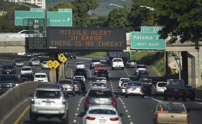 In this Saturday, Jan. 13, 2018 photo provided by Civil Beat, cars drive past a highway sign that says &quot;MISSILE ALERT ERROR THERE IS NO THREAT&quot; on the H-1 Freeway in Honolulu. The state emergency officials announced human error as cause for a statewide announcement of an incoming missile strike alert that was sent to mobile phones. (Anthony Quintano/Civil Beat via AP)