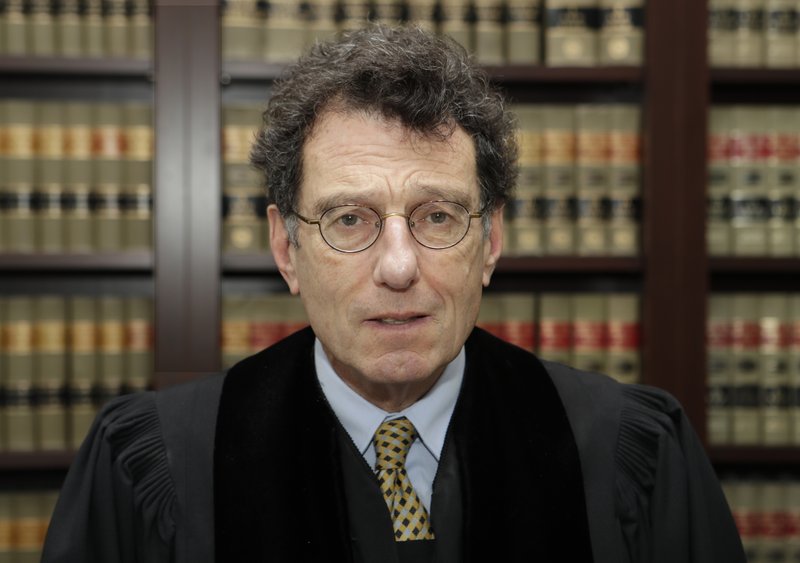 Judge Dan Polster poses in his office, Thursday, Jan. 11, 2018, in Cleveland. Polster has invited Ohio's attorney general Mike DeWine to brief him on the impact of the opioid epidemic. Polster is overseeing a consolidated case involving dozens of lawsuits filed by communities around the country against drugmakers and drug distributors. (AP Photo/Tony Dejak)