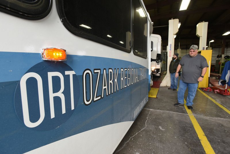 NWA Democrat-Gazette/FLIP PUTTHOFF
Jason Lance (left), operations manager with Ozark Regional Transit and John Williams, transit coordinator, look over a new bus delivered Saturday Jan. 13 2018 to ORT headquarters in Springdale. It is one of eight new buses ORT will receive.