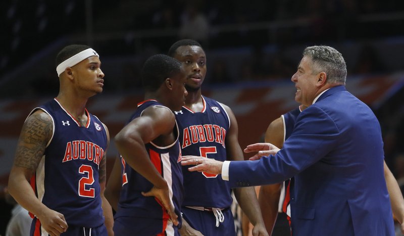 Auburn head coach Bruce Pearl talks with Auburn guard Bryce Brown (2), Auburn guard Jared Harper, center, and Auburn guard Mustapha Heron (5) during a time out in the second half of an NCAA college basketball game Tuesday, Jan. 2, 2018, in Knoxville, Tenn.