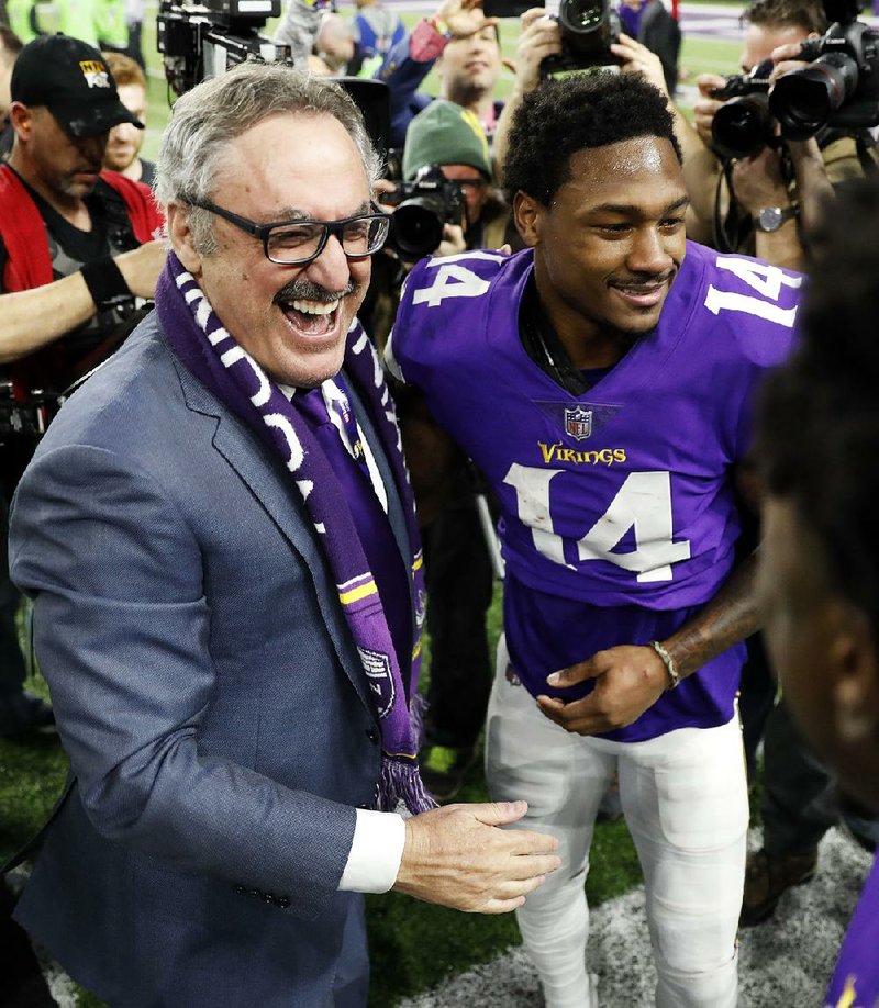 Minnesota Vikings owner Zygi Wilf (left) celebrates with wide receiver Stefon Diggs after Sunday’s 29-24 victory over the New Orleans Saints in Minneapolis.