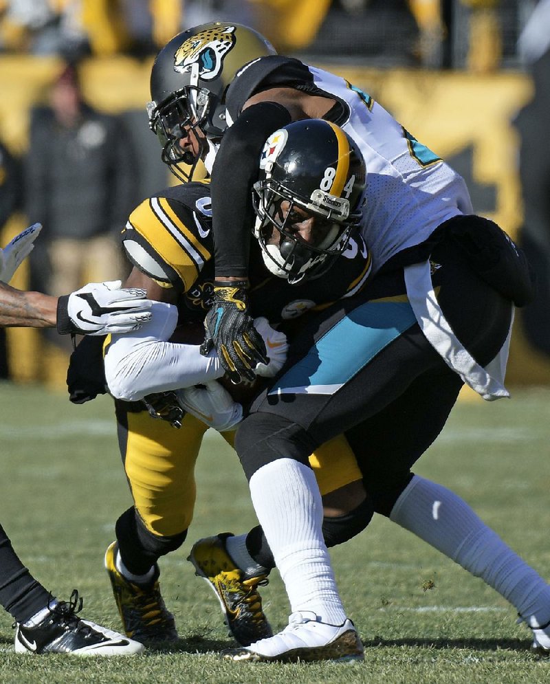 Jacksonville Jaguars cornerback Jalen Ramsey tackles Pittsburgh Steelers wide receiver Antonio Brown (84) as Brown makes a catch during the fi rst half Sunday in Pittsburgh. Ramsey said the Jaguars “are going to the Super Bowl and we are going to win [it].” 