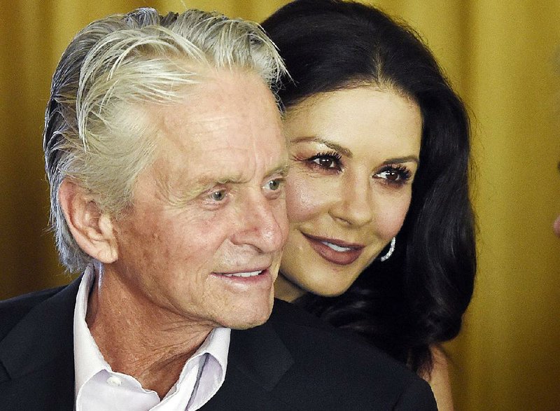 In this Dec. 9. 2016, file photo, actor Michael Douglas and his wife, actress Catherine Zeta-Jones, attend a party at the Beverly Hills Hotel in Beverly Hills, Calif.  