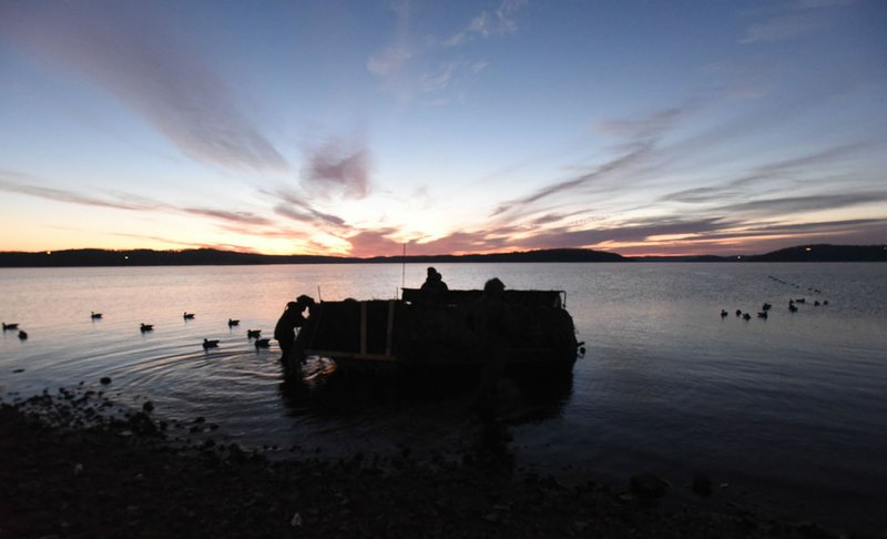 Decoys are set at dawn while hunters settle into Russell Gardner’s boat blind on Beaver Lake. Gardner scouts areas of the lake and hunts in coves and on points where he sees ducks circle and land.