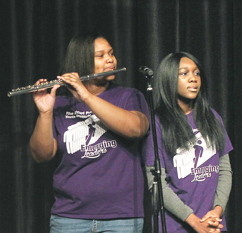The Sentinel-Record/Richard Rasmussen INSPIRATIONAL RENDITION: Khynnedi Murry, left, and Georgia Grimand perform with the Uzuri Project Youth Institute during the 20th Annual Martin Luther King Jr. Day Celebration at Horner Hall Monday. The group of students used their musical and vocal talents to present their rendition of King's "I have a dream" speech.
