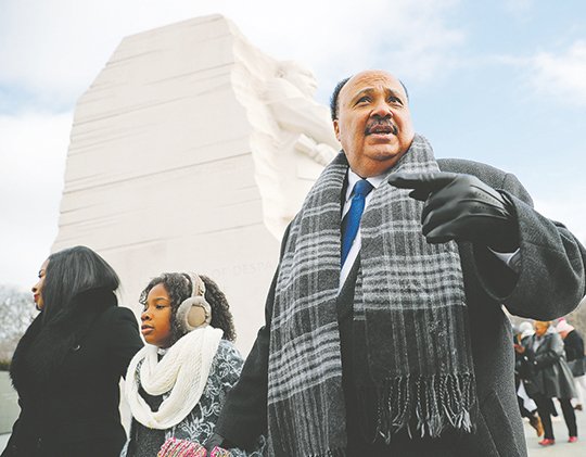 The Associated Press LUTHER'S LEGACY: Martin Luther King III, right, with his wife Arndrea Waters, left, and their daughter Yolanda, 9, center, during their visit to the Martin Luther King Jr., Memorial on the National Mall in on Monday in Washington. The son of the late U.S. civil rights activist Martin Luther King Jr., and his family had earlier participated in an event commemorating the life and legacy of his father.