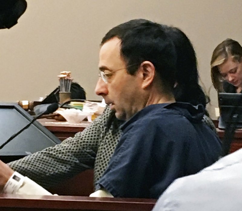 AP Photo/David Eggert Former Michigan sports doctor Larry Nassar sits in court Tuesday, Jan. 16, 2018, in Lansing, Mich., at the start of his four-day sentencing hearing for sexually assaulting young gymnasts. Dozens of women and girls who were victims will be allowed to speak. Judge Rosemarie Aquilina is expected to order a sentence Friday, Jan. 19.