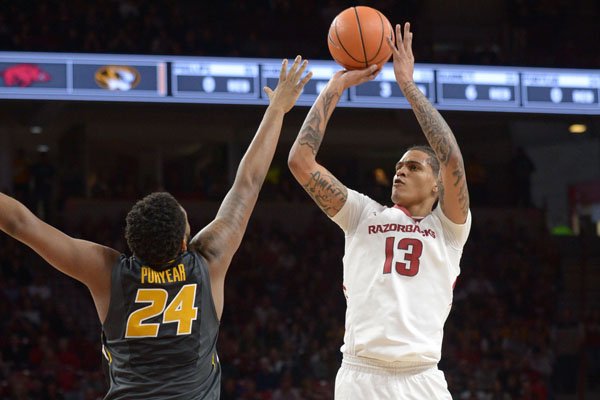 Arkansas forward Dustin Thomas shoots over the top of Missouri forward Kevin Puryear during a game Saturday, Jan. 13, 2018, in Fayetteville. 