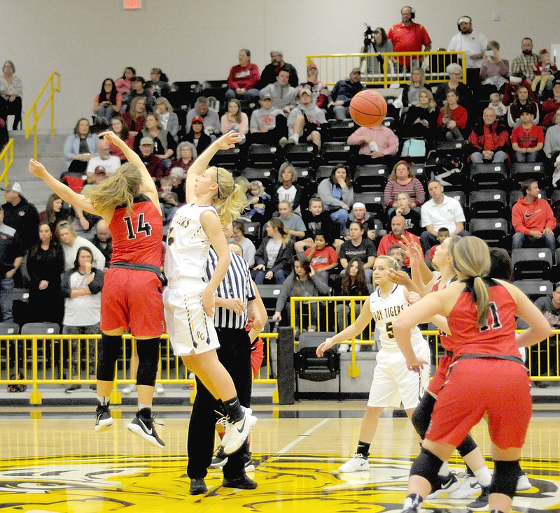 MARK HUMPHREY ENTERPRISE-LEADER/Alexis Roach (left) jumps center against Prairie Grove's Sarah James Stone. The 5-foot-8 Roach transferred to Farmington from Siloam Springs and has helped the Lady Cardinals with her athleticism.