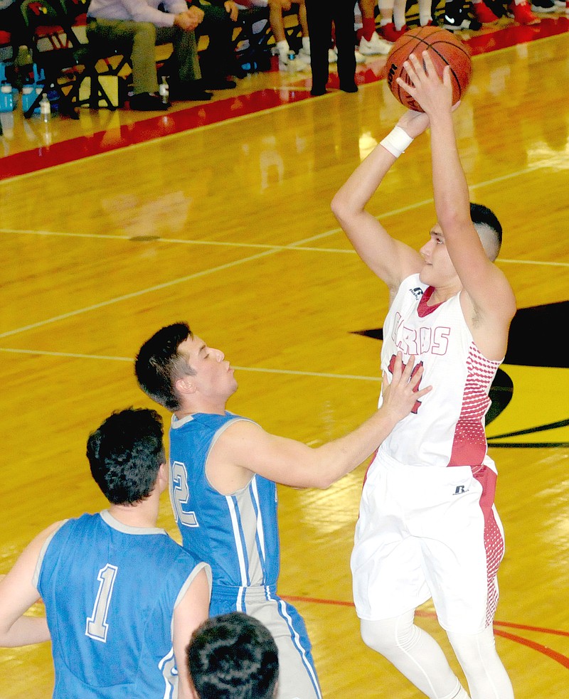 MARK HUMPHREY ENTERPRISE-LEADER Farmington senior Skyler Montez shoots over Greenbrier defenders in the lane. Farmington lost 59-46 to the visitors on Friday, Jan. 5.