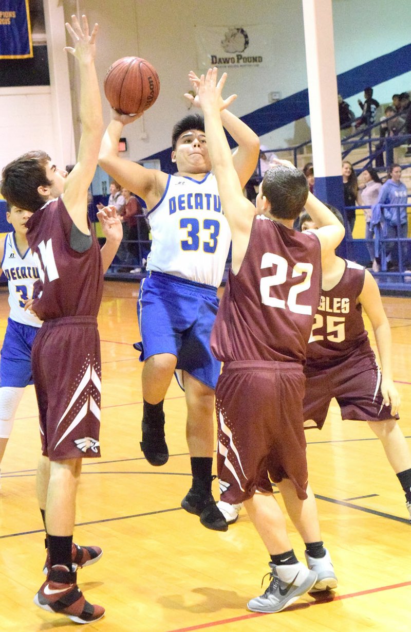 Westside Eagle Observer/MIKE ECKELS Sam Deleon (Decatur 33) goes up for a one-handed layup in the third quarter of the Decatur-Huntsville junior high boys' basketball game at Peterson Gym in Decatur Jan. 8.