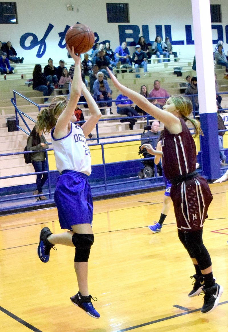 Westside Eagle Observer/MIKE ECKELS Decatur's Hailey Shaffer (left) tries to put up a jumper from the corner of the lane as a Lady Eagles player goes for the block during the first quarter of the Decatur-Huntsville junior high girls' basketball game at Peterson Gym in Decatur Jan. 8.