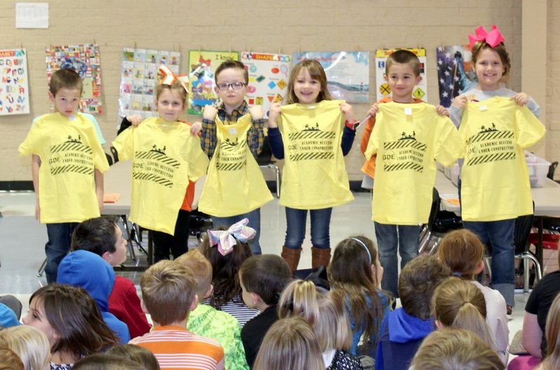 Westside Eagle Observer/PHOTO SUBMITTED Grade-level winners of the PAWS ("Pawsitive" and Wise Students) award for the month display the T-shirts presented to them at the Jan. 8 Rise and Shine assembly. PAWS award winners for the month of January are Wyatt Morgan (left), McKenzie Baker, Triston Daniels, Ashlynn Mitchell, Kaleb Holloway and Kloey Fields.