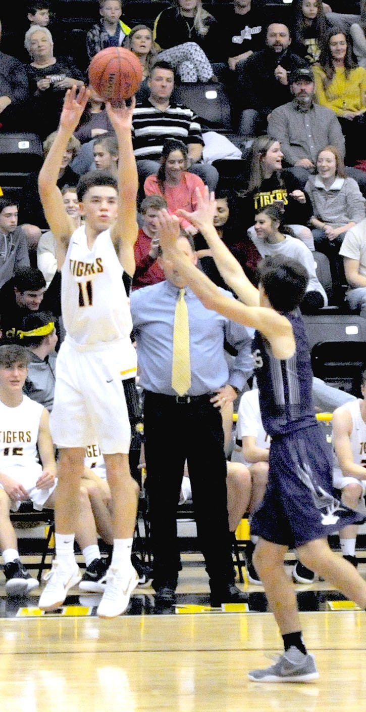 MARK HUMPHREY ENTERPRISE-LEADER Prairie Grove senior D.J. Pearson launches a 3-point shot from the corner. Pearson made one three and scored 11 points as the Tigers beat Elkins, 60-36, Friday.