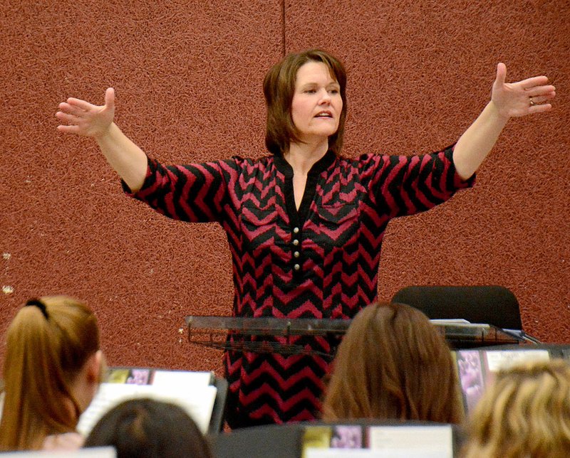 Janelle Jessen/Herald-Leader Janna Lane worked with a group of students at Siloam Springs High School on Friday. Lane has been chosen to direct the Region 8 All Region Band later this month.