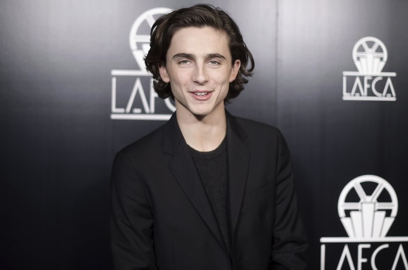FILE - In this Jan. 13, 2018, file photo, Timothee Chalamet attends the 43rd Annual Los Angeles Film Critics Association Awards in Los Angeles. Chalamet said he will donate his salary for an upcoming Woody Allen film to charities fighting sexual harassment and abuse. (Photo by Richard Shotwell/Invision/AP)