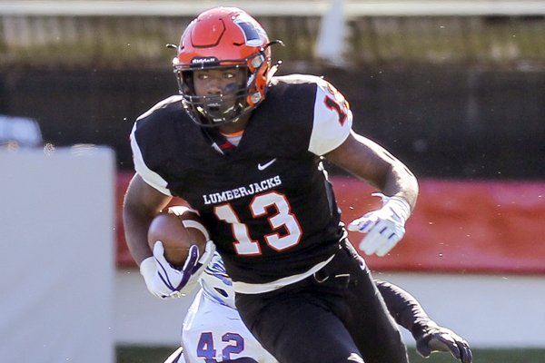 Warren receiver Treylon Burks runs past Arkadelphia defender Demarco Britton during the Class 4A state championship game on Saturday, Dec. 9, 2017, in Little Rock. 