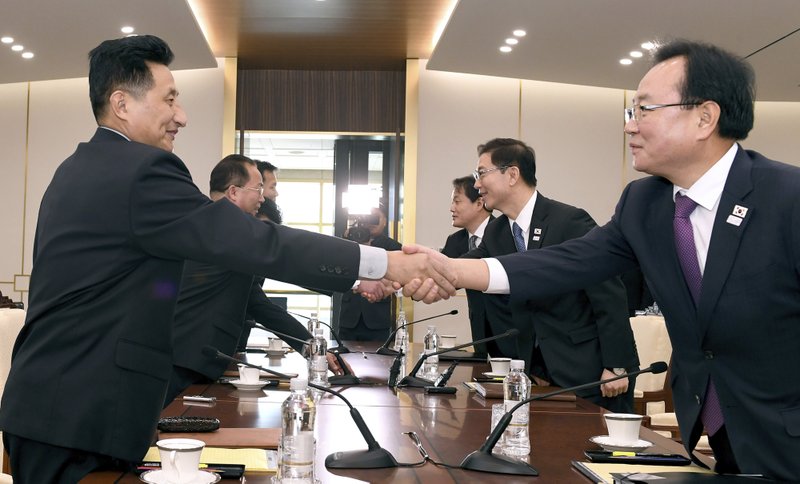 In this photo provided by South Korea Unification Ministry, South Korean Vice Unification Minister Chun Hae-sung, center right, shakes hands with the head of North Korean delegation Jon Jong Su during their meeting at Panmunjom in the Demilitarized Zone in Paju, South Korea, Wednesday, Jan. 17, 2018. The two Koreas are meeting Wednesday for the third time in about 10 days to continue their discussions on Olympics cooperation, days ahead of talks with the IOC on North Korean participation in the upcoming Winter Games in the South. (South Korea Unification Ministry via AP)

