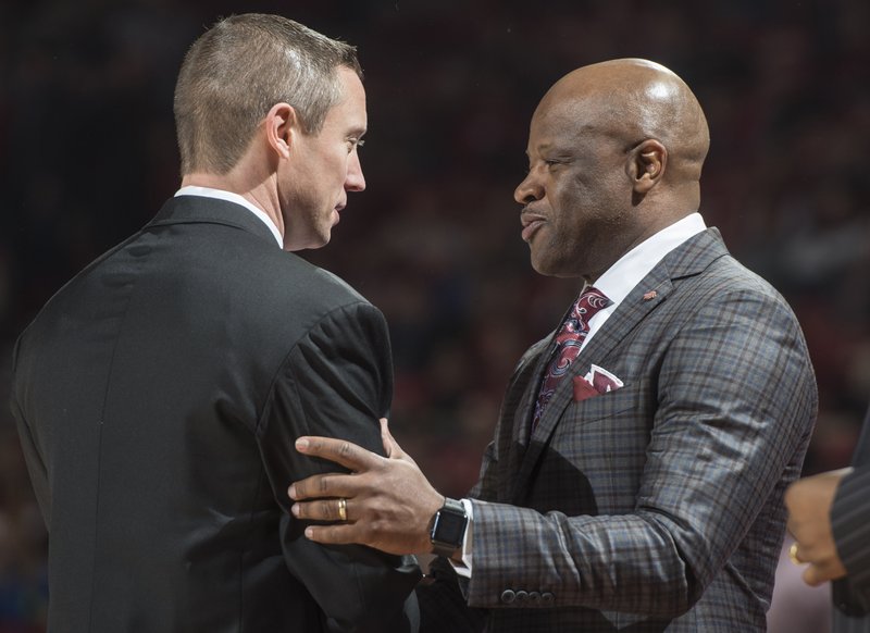 Arkansas head coach Mike Anderson (right) chats with Florida head coach Mike White before the game Thursday Dec. 29, 2016 at Bud Walton Arena in Fayetteville.