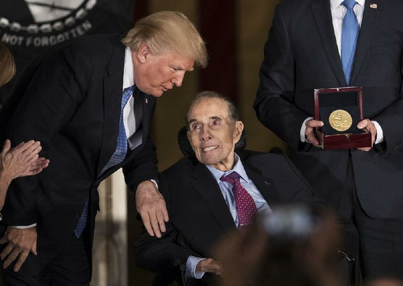 President Donald Trump joins former Senate Majority Leader Bob Dole under the U.S. Capitol dome Wednesday as Dole receives the Congressional Gold Medal. 