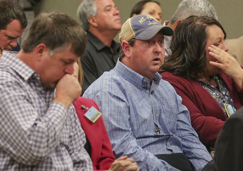 Jason Henson (left) and Phillip Campbell, co-owners of C&H Hog Farms along with Richard Campbell, listen Wednesday as the Arkansas Pollution Control and Ecology Commission gives its decision. 