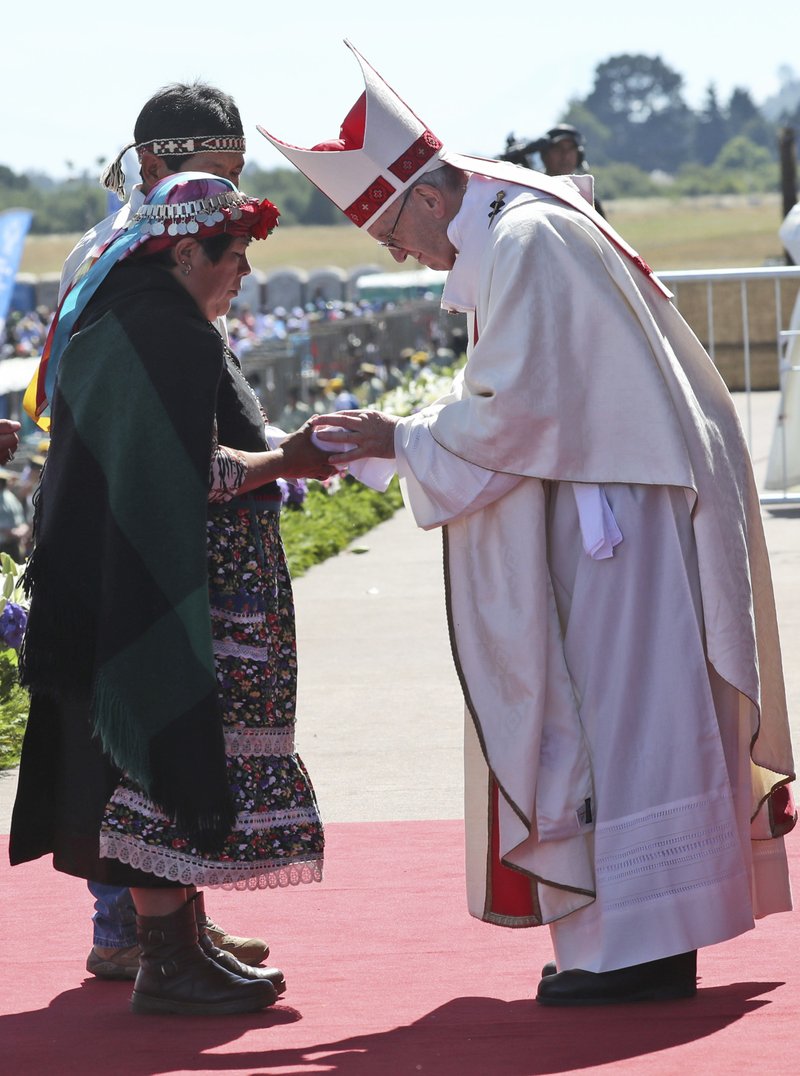 A Mapuche woman greets Pope Francis during the offertory during a Mass at the Maquehue Air Base, in Temuco, Chile, Wednesday, Jan. 17, 2018. Francis is urging the Mapuche people to reject violence in pushing their cause.
Francis made the comments Wednesday while celebrating Mass in Temuco. The city is the capital of the Araucania region, where many of Chile's estimated 1 million people of Mapuche descent live. (AP Photo/Alessandra Tarantino)