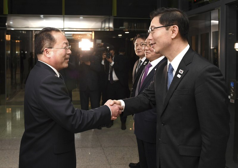 In this photo provided by South Korea Unification Ministry, South Korean Vice Unification Minister Chun Hae-sung, right, shakes hands with the head of North Korean delegation Jon Jong Su after a meeting at Panmunjom in the Demilitarized Zone in Paju, South Korea, Wednesday, Jan. 17, 2018. The rival Koreas agreed Wednesday to form their first unified Olympic team and have their athletes parade together during the opening ceremony of next month's Winter Olympics in the South, Seoul officials said. (South Korea Unification Ministry via AP)