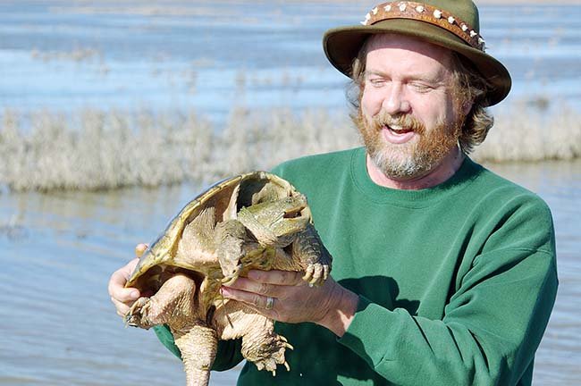 Survivalists should avoid the sharp jaws and claws of turtles like this common snapper, caught by Keith Sutton of Alexander, but a big turtle like this can provide food for several meals.