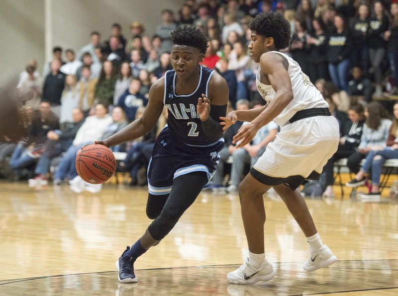 NWA Democrat-Gazette/CHARLIE KAIJO Springdale Har-Ber senior Tyler Garrett (2) dribbles past Bentonville High's Connor Deffebaugh (10) during a basketball game on Friday, January 12, 2018 at Bentonville Tiger Arena. Garrett is 12 points away from becoming the second player in Har-Ber history to eclipse the 1,000 career point mark. The Wildcats (14-3) travel to Fayetteville tonight.