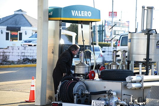 The Sentinel-Record/Grace Brown MAINTENANCE CHECK: Kevin Gray with American Petroleum calibrates pumps five and six where two credit card skimmers were found at the Valero, 1201 Central Ave., on Thursday. Gray said the skimmers could have been there for some time due to the fact pumps are checked on a yearly basis.