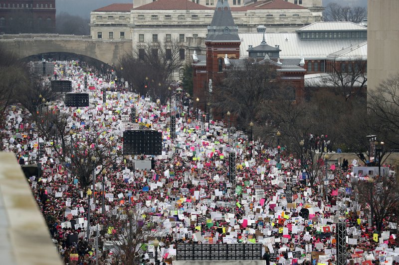 FILE - In this Jan. 21, 2017, file photo, a crowd fills Independence Avenue during the Women's March on Washington, in Washington. The astounding sea of women in bright pink hats in Washington, across the nation and beyond, often described as the largest single-day protest in U.S. history, became the face of the resistance to Trump and his agenda. It inspired thousands of women to do something they'd never done before: explore a run for political office. (AP Photo/Alex Brandon, File)