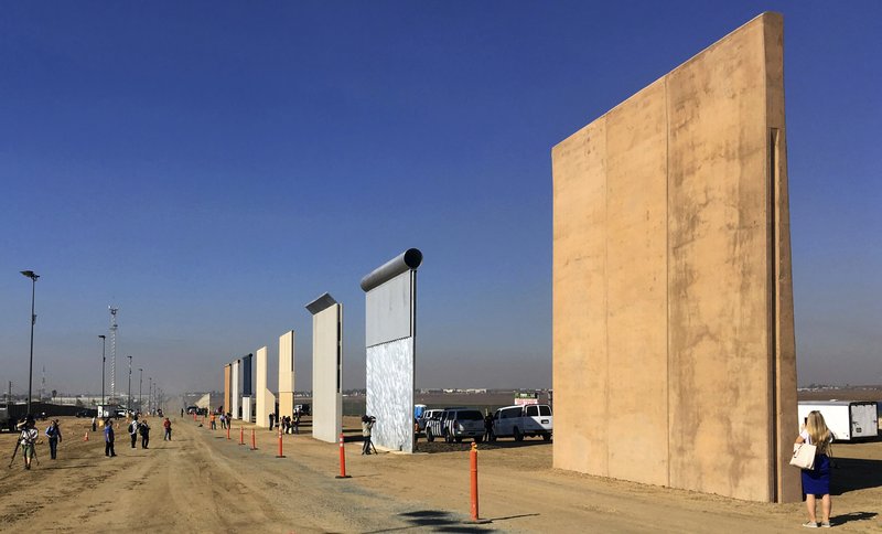 This Oct. 26, 2017 file photo shows prototypes of border walls in San Diego. Rigorous testing of prototypes of President Donald. A U.S. official says recent testing of prototypes of President Donald Trump’s proposed wall with Mexico found their heights should stop border crossers. U.S. tactical teams spent three weeks trying to breach and scale the models in San Diego. An official with direct knowledge of the results said they point to see-through steel barriers topped by concrete as the best design. The official spoke to The Associated Press on condition of anonymity because the information is not authorized for release. 