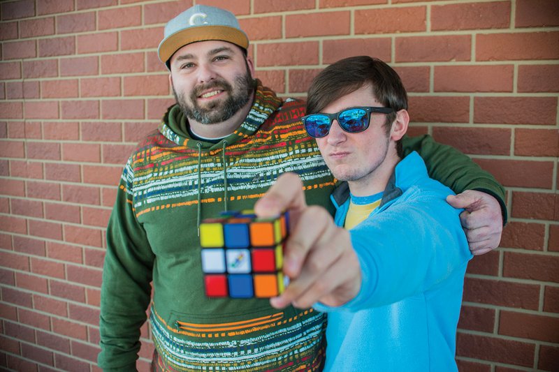 Cole Williams, 17, right, holds a Rubik’s Cube out while his manager, Chris Fisher, stands next to him. The two work at Sheridan’s Sonic Drive-In, and for Christmas, Fisher helped raise money to purchase Williams a pair of Enchroma glasses to help with his color blindness. 