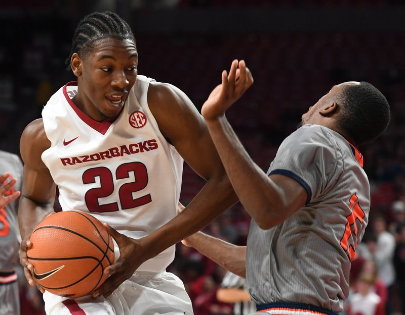 Arkansas' Gabe Osabuohien looks for room while Bucknell's Nate Jones defends Sunday Nov. 12, 2017 at Bud Walton Arena in Fayetteville.