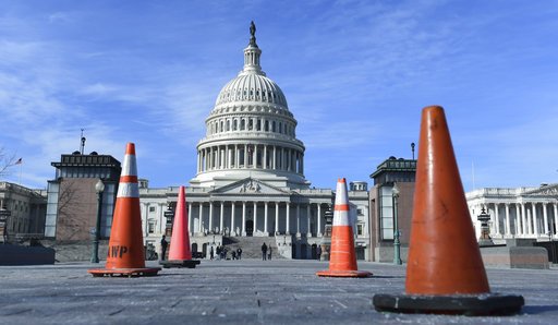 Construction cones used to cover walkway flaws, stand along the sidewalk on Capitol Hill in Washington, Friday. On the edge of a government shutdown, a divided House voted late Thursday to keep the government open past a Friday deadline — setting up an eleventh-hour standoff in the Senate, where Democrats have vowed to kill the measure. (AP Photo/Susan Walsh)