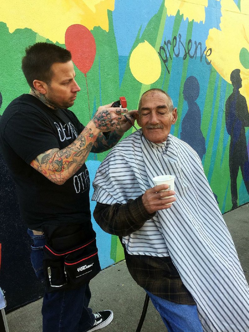 Hairdresser Clayton Keith gives a free haircut to a man in December. He volunteers to cut hair for homeless people. “He’s the type of person that always wants to give, never expecting to receive,” says his friend Jeff Kulp.