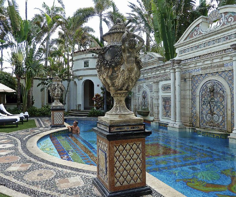 David Tamuty of Fort Lauderdale, Fla., lounges in the pool at The Villa Casa Cauarina, a boutique hotel that was the home of fashion designer Gianni Versace in Miami Beach, Fla.