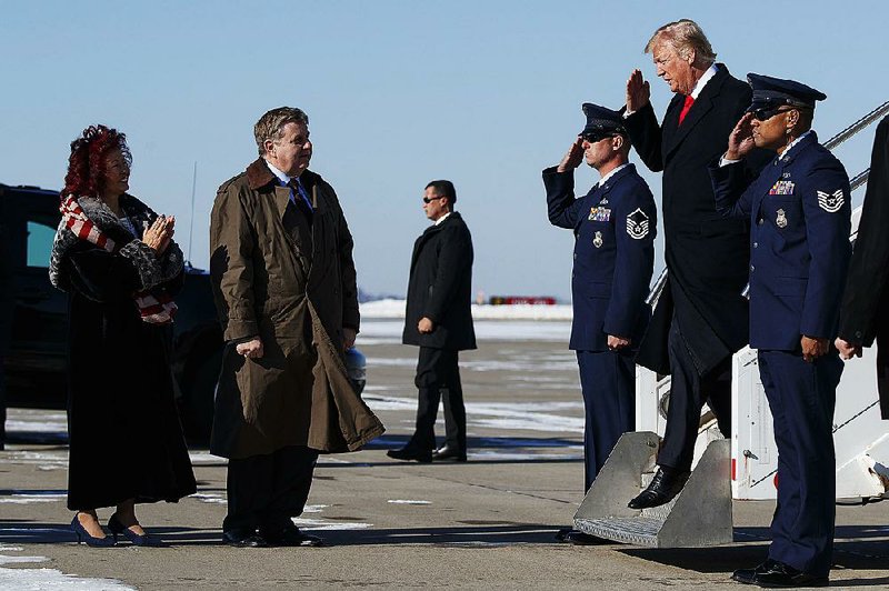 Rick Saccone (second from left) and his wife, Yong, greet President Donald Trump as he arrives Thursday at the Pittsburgh airport.