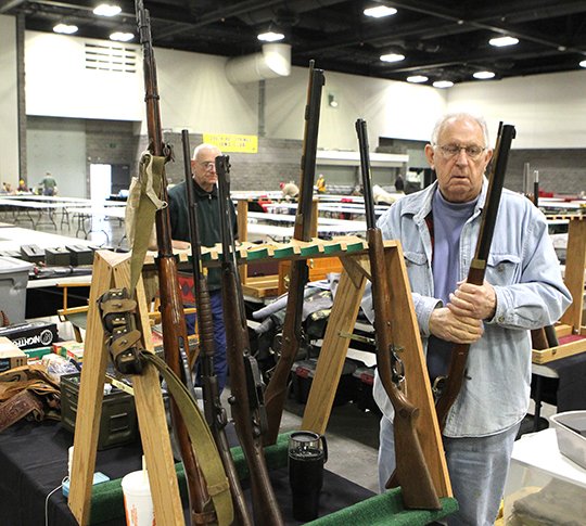 J.M. Harbet sets up one of over 110 vendor booths at the Hot Springs Convention Center in preparation for the South Hot Springs Lions Club semiannual gun and knife show on Jan. 19, 2018. - File photo by Richard Rasmussen of The Sentinel-Record